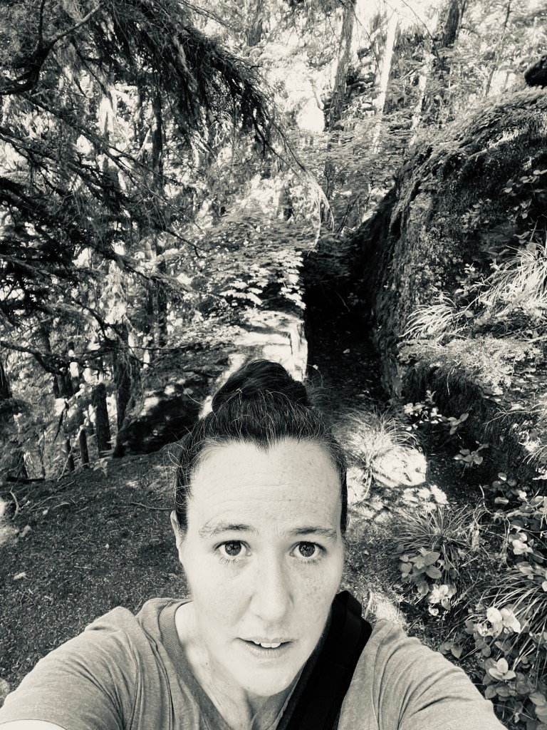 black and white photo of the author out in the woods.